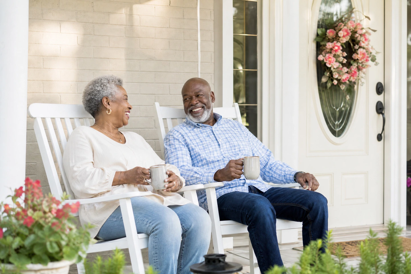 Smiling senior couple relaxing together on their front porch